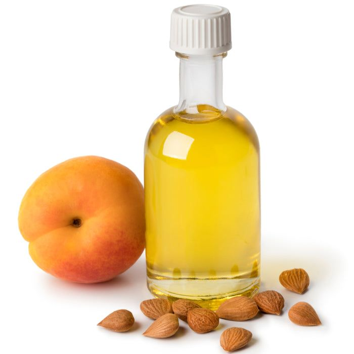 a glass bottle filled with apricot kernel oil